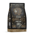 The front of a 12 ounce bag of Bones Coffee Company Bourbon Barrel Aged coffee. There is a barrel with the Bones Coffee Company skull logo on it on the art.