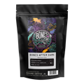 A black stand-up pouch of Bones After Dark dark roast coffee from Bones Coffee Company, featuring a colorful illustrated label on the front.