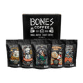 The Classic Comforts gift box. There are five four ounce bags in front of a bones coffee box. From left to right their names are salted caramel, french toast, salty siren, cinnamon roll, and french vanilla.