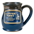 The front of the Bones Coffee Company Coffee First Handthrown Mug. It has the phrase “Coffee first, your nonsense second” on the golden medallion. The mug is federal blue colored with a cinnamon and white glaze.