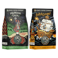 The front of two twelve ounce bags of Bones Coffee Company flavored coffee. The bag on the left is Highland Grog, and the bag on the right is Salted Caramel. Highland Grog is butterscotch and caramel flavor, Salted Caramel is salted caramel flavor.