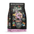 The front of a 12 ounce bag of Bones Coffee Company Oh Fudge coffee. Its flavor is hazelnut and fudge, and it has a skeleton in pink rabbit pajamas slipping with a plate of fudge on the art.