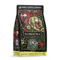 The front of a 12 ounce bag of Bones Coffee Company Sumatra single-origin coffee. It is a dark roast, and it has one red and one yellow tiger with flowers scattered around them on the art.