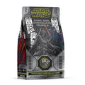 The front of a 12 ounce bag of Bones Coffee Company Dark Side Chocolate Truffle flavored coffee. Its flavor is chocolate truffle, and it is inspired by Lucasfilm’s Star Wars. The art has Darth Vader, a Storm Trooper, and Emperor Palpatine on it.