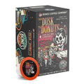 The front of the Bones Coffee Company From Dusk til Dawn 12 Count Bones Cups box. Its flavor is jelly donut, and it has a skeleton dressed like a vampire holding a jelly donut while people leave a donut shop on the art.