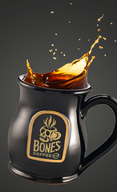 Black mug with Bones Coffee Co logo and coffee splashing out