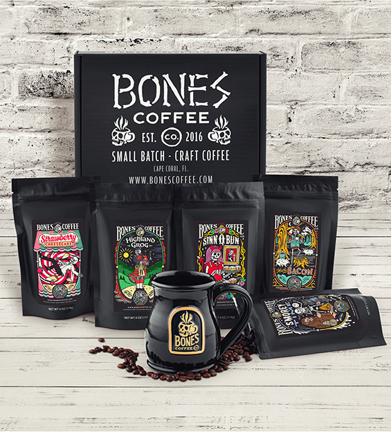 Bones Coffee Company product display with various coffee bags and a branded mug on a wooden surface.